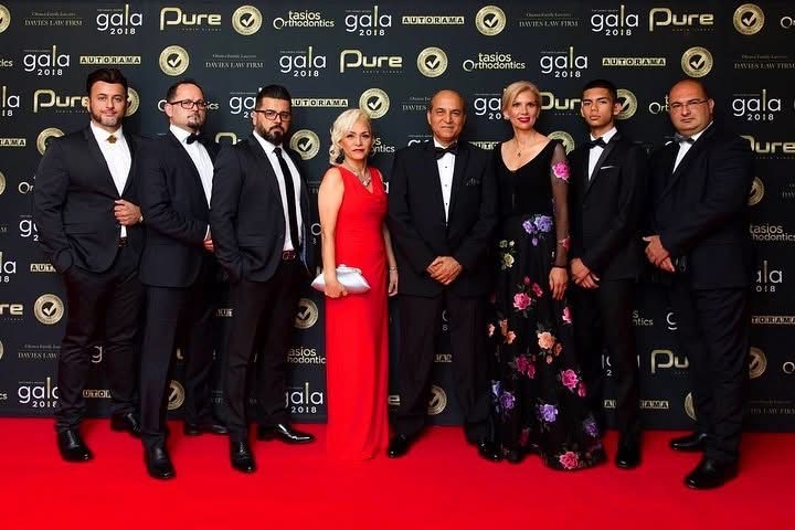 Autorama leadership and associates posing at a gala event